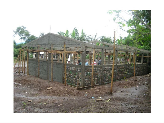 Volunteer with a lot of bottle builds green school